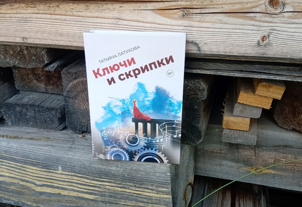 Фото книги Ключи и скрипки на фоне заготовок из дерева